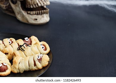 Fun Food For Kids. Halloween Mummy Hot Dogs.  Wieners Wrapped In Croissant Rolls To Look Like Mummies On A Plate. Alternative To Candy.