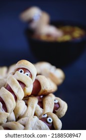 Fun Food For Kids. Mummy Hot Dogs (or Pigs In A Blanket) On A Blue Rustic Table With A Bowl Of Ketchup And Mustard Dip, With Spider Web Design. Selective Focus With Blurred Foreground And Background.