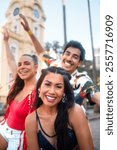 Fun friends enjoy Carnival Festival in Brazil. Street of historic city with people celebrating Carnaval