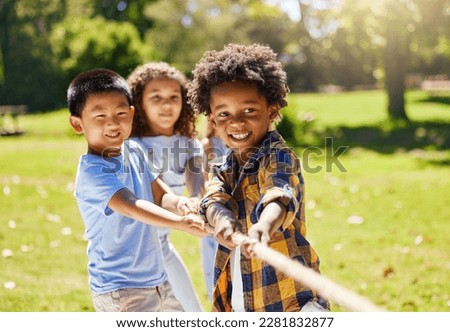 Fun, games and kids playing tug of war together outdoor in a park or playground in summer. Friends, diversity and children pulling a rope while being playful fun or bonding in a garden on a sunny day