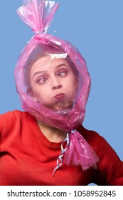 Fun Girl With Head Inside Candy Wrapper On Blue Background