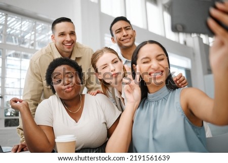 Fun, goofy or playful team selfie on phone and having fun, goofing around or making silly face expressions. Diverse or cheerful group of business friends or creative colleagues posing on social