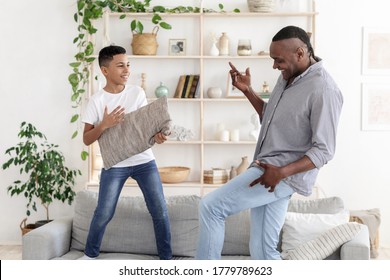 Fun With Grandfather. Happy Black Preteen Boy Fooling With Grandpa At Home, Playing And Dancing