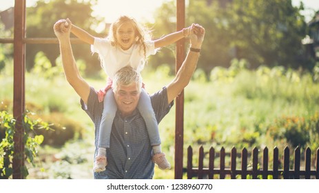  Fun With Grandpa. Grandfather And Granddaughter Spending Time Together In Nature. Copy Space.