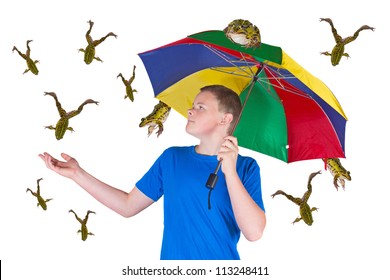 Fun Image Of An Attractive Young Man Sheltering Under A Colourful Umbrella Holding Out His Hand In Surprise Because It Is Raining Frogs Instead Of Raindrops Isolated On White