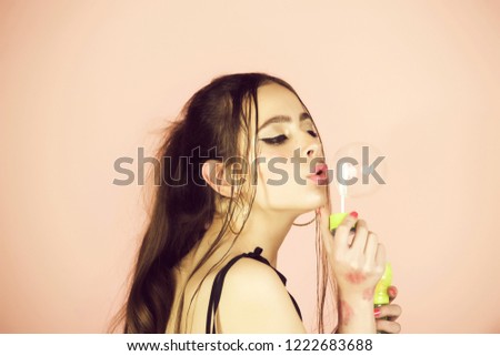Fun and joy. Woman play with soap balloon. Bubble blower in hand of fashion model. Beauty and fashion. Girl with glamour makeup and hair.