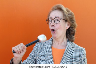 Fun mature woman holding a microphone