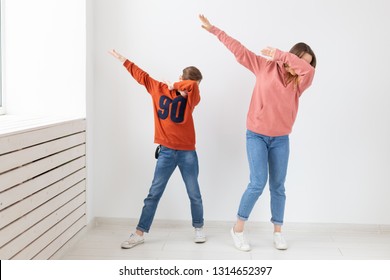 Fun, Mothers Day, Children And Family Concept - Teen Boy And His Mom Funny Dancing On White Background