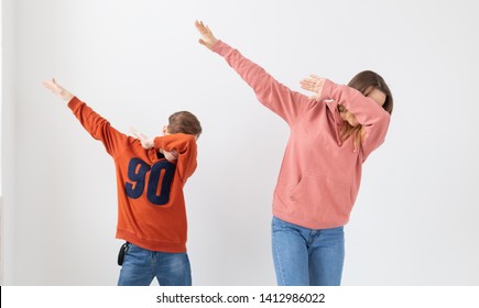 Fun, Mothers Day, Children And Family Concept - Teen Boy And His Mom Funny Dancing On White Background