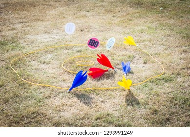 Fun Outdoor Children's Game Of Lawn Darts Into A Ring Of Targets Up To 100 Points On A Sunny Day During A Summer Holiday, Rustic Filter Used On Dry Grass In A Garden