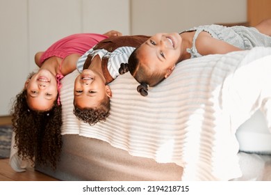 Fun, Playful And Silly Kids Lying On A Bed With Cute Hairstyle And Smiling Portrait. Little Siblings Relaxing, Playing Indoors Showing Growth, Child Development And Childhood Innocence