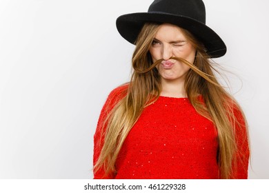 Fun prank joy entertainment concept. Silly lady playing with hairs. Young playful girl making mock moustache using her own hair. - Powered by Shutterstock