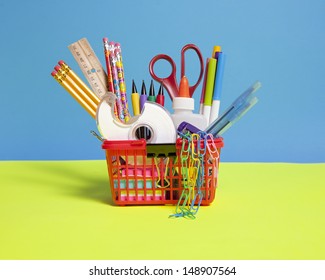 A fun red shopping basket full of school supplies. - Shutterstock ID 148907564