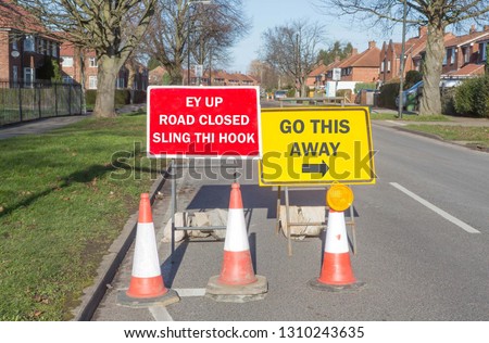 Fun road sign informing drivers that the road is closed and to go another way written in a Yorkshire dialect.