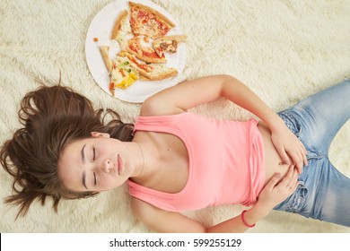 Fun Sad Overeat Girl Lying With Pizza Pieces