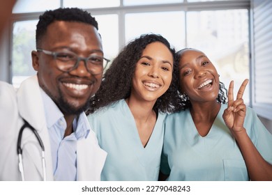 Fun selfie of doctor and nurses in hospital pulling silly faces and laughing - Powered by Shutterstock