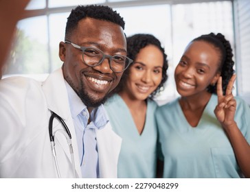 Fun selfie of three healthcare professionals stand in a row informal candid pose - Powered by Shutterstock