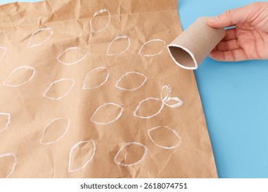 Fun stamping activity using cardboard tubes to print fish and bubbles on kraft paper, perfect for homeschooling, creative learning, eco craft kits, kids art books, and DIY brands.