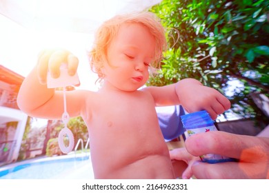 Fun Summer Day With Family. Little Girl Plays With Soap Bubbles. Happy Child Blowing Bubbles.