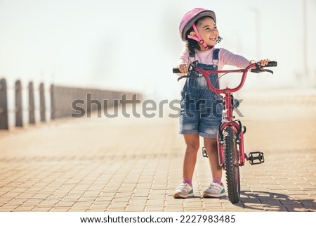 Fun, thinking and girl cycling with a bike in the city for sustainability, carbon footprint and eco friendly transport. Happy, smile and child with an idea and a bicycle in the street for happiness