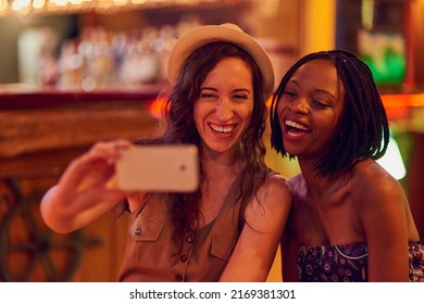 Fun Times With My Favourite Person Ever. Cropped Shot Of Two Young Friends Taking A Selfie In A Bar.