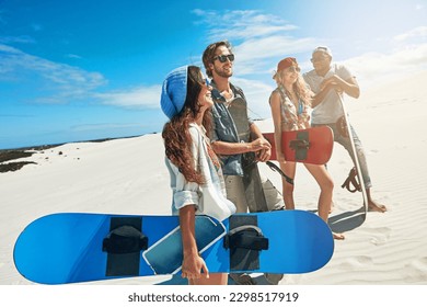 Fun under the desert sun. a group of young friends sandboarding in the desert. - Powered by Shutterstock