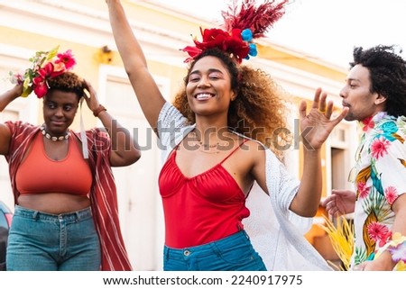 Fun woman dancing Carnival in the street. Brazilian people enjoying Carnaval festival in Brazil