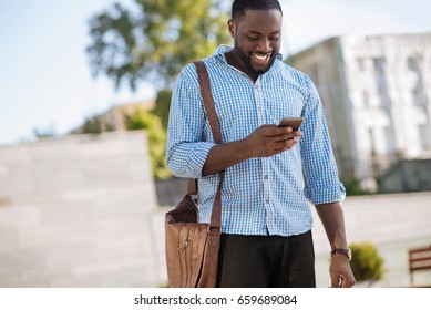 Fun young man checking notifications on his phone