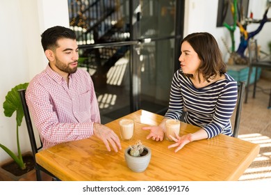 Fun Young Man And Woman Getting To Know Each Other During Their First Date At A Coffee Shop