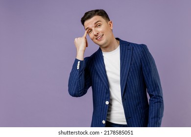 Fun young successful employee business man lawyer 20s wear formal blue suit white t-shirt work in office stroke the eyebrow with his little finger isolated on pastel purple background studio portrait