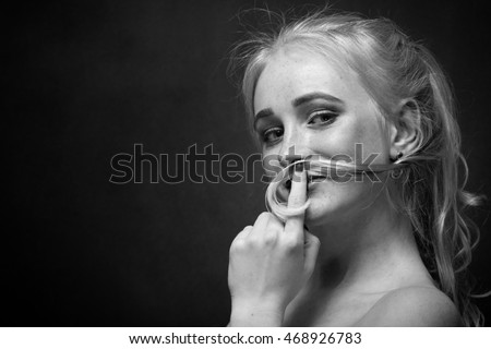 fun young woman making mustache from her hair, monochrome