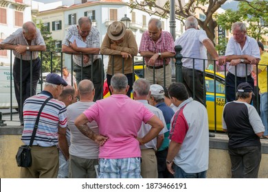 Funchal At Madeira, Portugal - August 01, 2014: Group Of Older Men Looking To Two Man Playing Cards