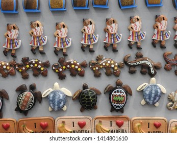 Funchal, Portugal -30 Mai 2019: Madeira Souvenirs And Memorabilia. Woman With Famous Local Clothing Wear. I Love Madeira. Gecko And Turtle On Fridge Magnet. Part Of A Serie.


