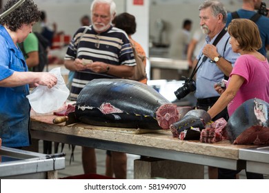  FUNCHAL, PORTUGAL - SEPTEMBER 2, 2016: Tourists visiting the fish market of the famous Mercado dos Lavradores  in Funchal, capital city of Madeira, Portugal