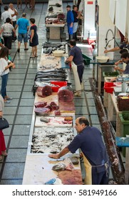 FUNCHAL, PORTUGAL - SEPTEMBER 2, 2016: Fish sellers at Mercado dos Lavradores, the famous fish and seafood market of Funchal, the capital of Madeira island
