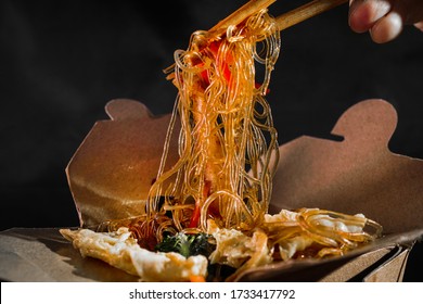 Funchoza With Seafood. Man Eating Chopsticks Spaghetti With Vegetables. Food Delivery. Takeaway Food. Chinese Food. Japanese Noodles