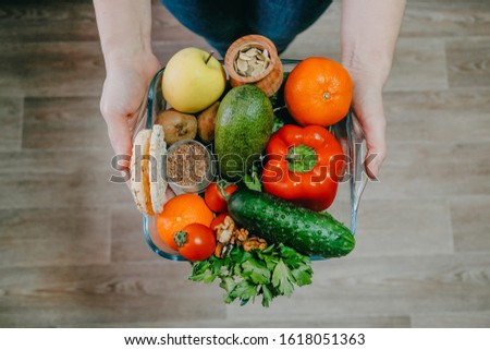 Functional foods, Health Super food concept very high in minerals, vitamins, antioxidants, omega 3. Various vegetables, fruits, nuts and seeds in woman hands.