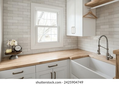 Functional and Stylish Laundry Room with Custom Cabinets and Countertop. Social Media and Copy Space. Wooden Countertops with Neutral Beige Subway Tile.