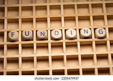 Funding, Raise Capital. Wooden Dice Arranged In A Box, To The Word Funding. Money, Debt And Venture Capital. 