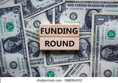 Funding Round Symbol. Concept Words 'Funding Round' On Wooden Blocks On A Beautiful Background From Dollar Bills. Business And Funding Round Concept.