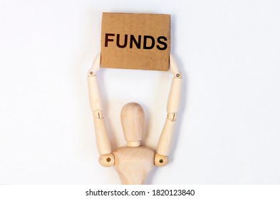FUNDS word on craft paper holding by a wooden person, financial concept. - Shutterstock ID 1820123840