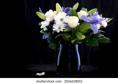 Funeral Bouquet Purple White Flowers, Sympathy And Condolence Concept On Blackbackground With Copy Space.