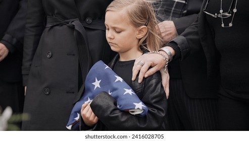 Funeral, cemetery and girl with American flag for veteran for respect, ceremony and memorial service. Family, depression and sad child by coffin in graveyard mourning military, army and soldier hero - Powered by Shutterstock