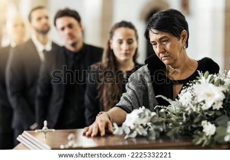 Funeral, death and coffin in church or Christian family gathering together for support. Religion, sad people and mourning loss or religious catholic men and women grief in church service over casket