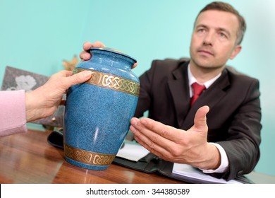 Funeral Director Showing Urn
