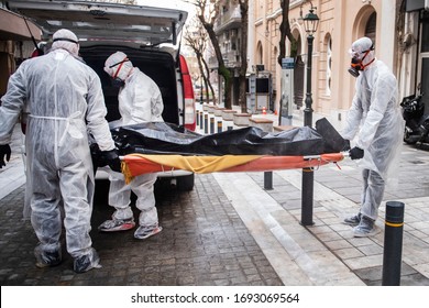 Funeral Home Employees Wear Protective Suits To Protect Themselves From Coronavirus, As They Carry A Dead Body Inside Bag.