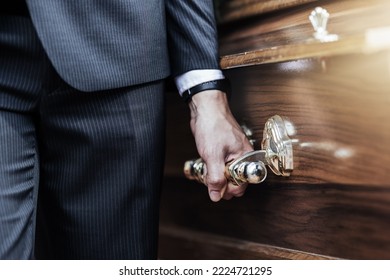 Funeral, man hands and holding coffin at a sad, death and church even of a person with casket. Support, loss and dead burial of a male at a religion, respect and mourning ceremony with a suit