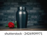 Funeral mourning urn next to a rose flower.