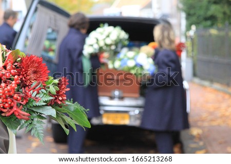 Funeral procession with flowers in car