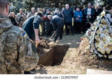 Funeral Of The Ukrainian Military. Civil And Military At The Funeral Ceremony Of The Deceased Soldier. Farewell To The Dead Soldiers. Burial In The Grave. War In Ukraine. Ukrainian Heroes Posthumously